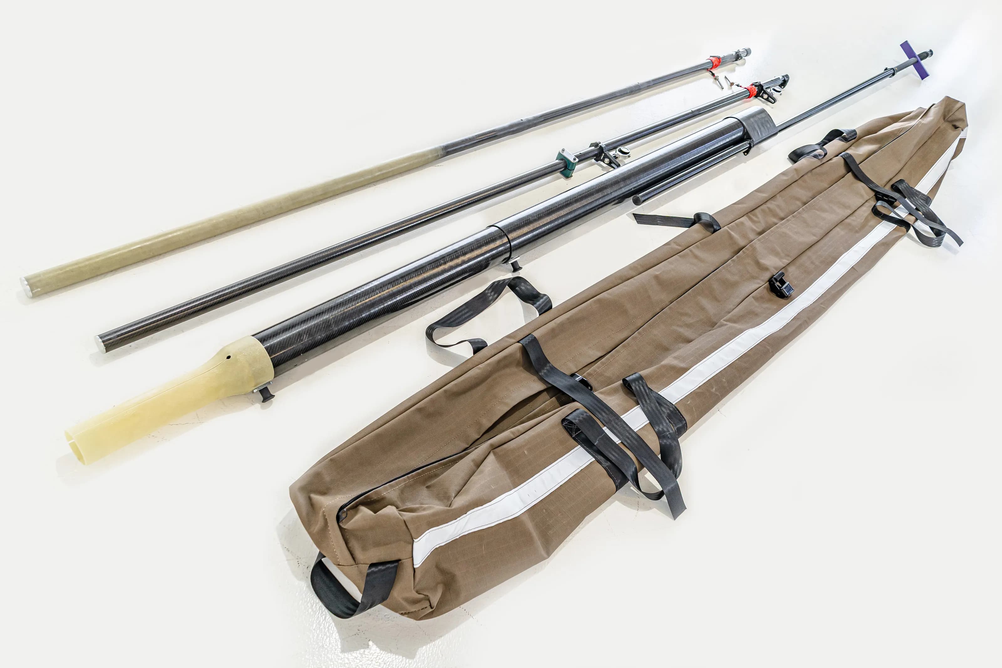 Feeder Pole and prism pole sections beside their carry bag