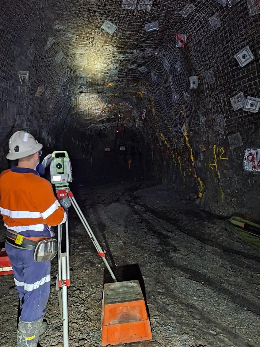 IBT surveyor picking up collars with a total station in an underground drive